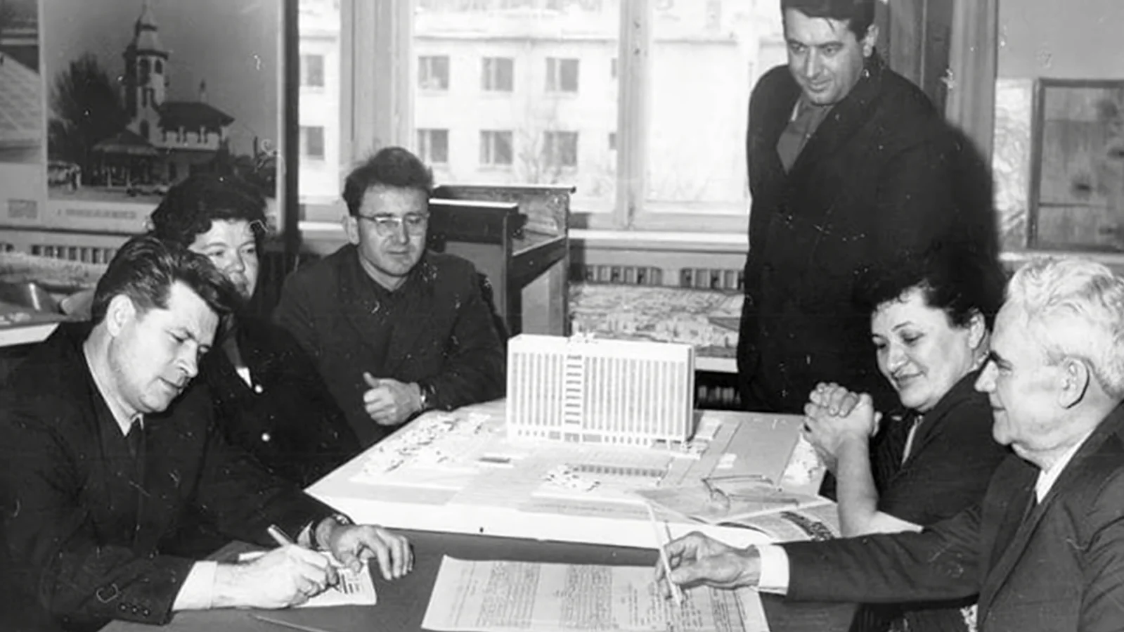 A group of architects, led by Petro Kazmirchuk, near the model of the building of Mykolaiv Regional State Administration. (Andriy Shynkarenko)